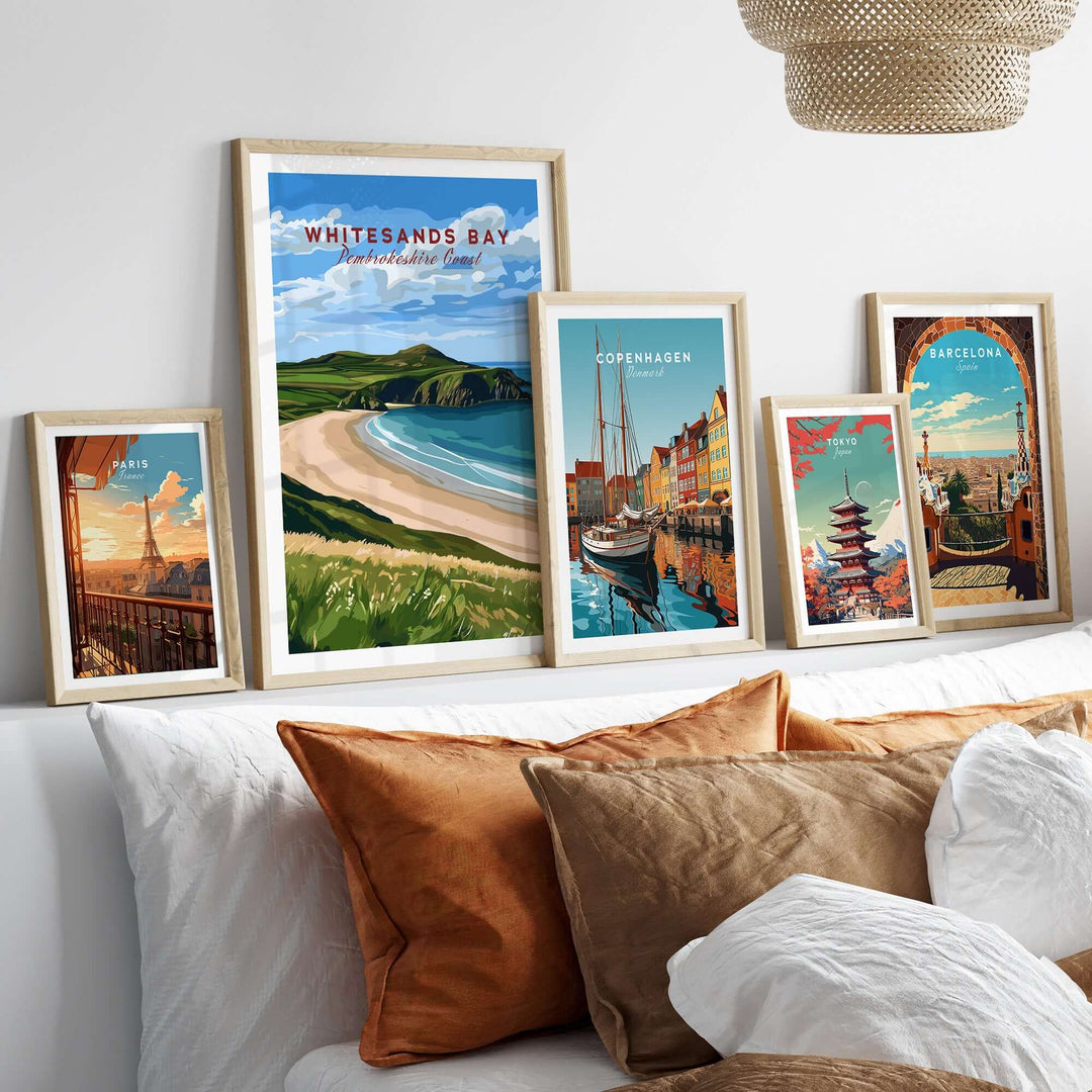 Framed Whitesands Bay Coastal View Poster and travel posters on a stylish couch, perfect wall art for wanderlust lovers.