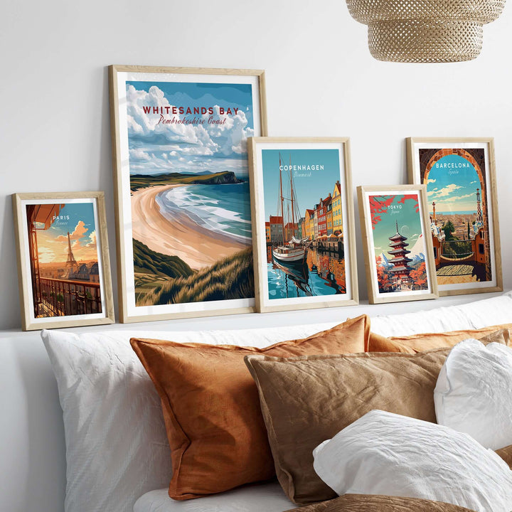 Framed Whitesands Bay Pembrokeshire print among other travel artworks in a cozy interior setting.