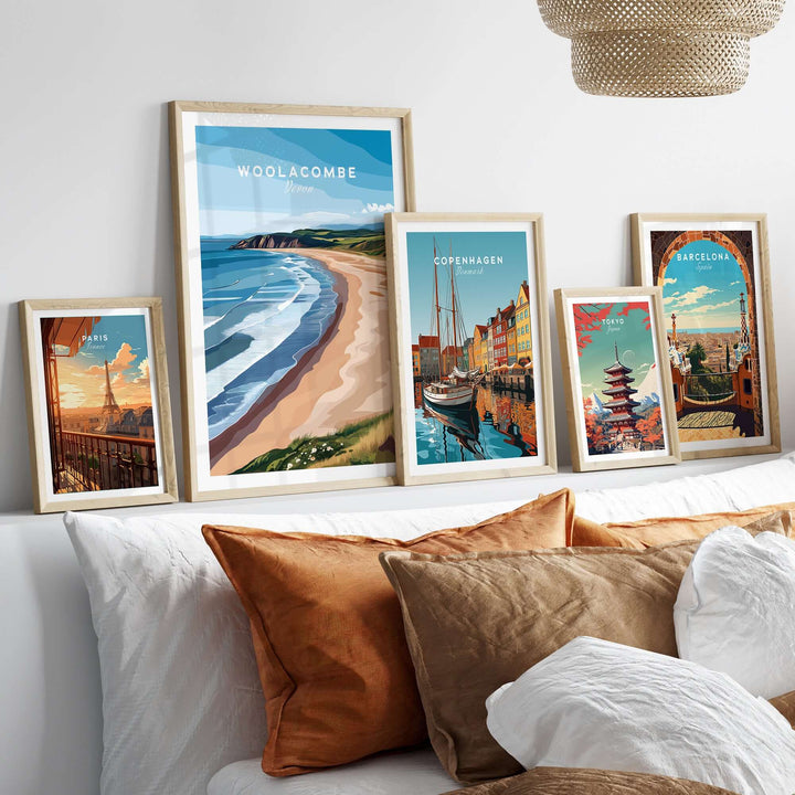 Collection of vibrant travel posters including Woolacombe Devon Long Beach Sunset, enhancing a cozy home decor setup.