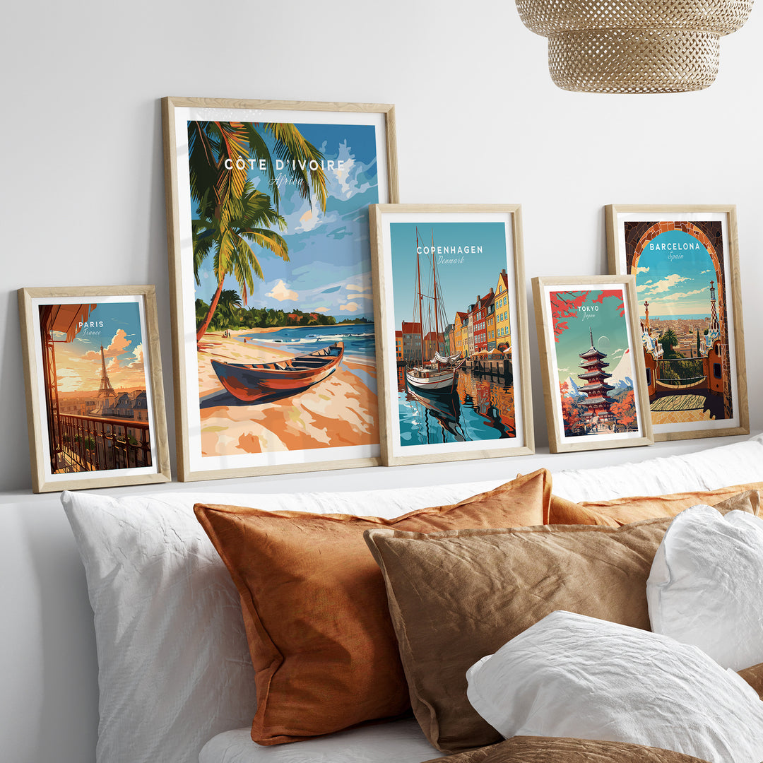 Stylish Côte d'Ivoire Beach Wall Art and colorful travel prints displayed above a cozy bed.