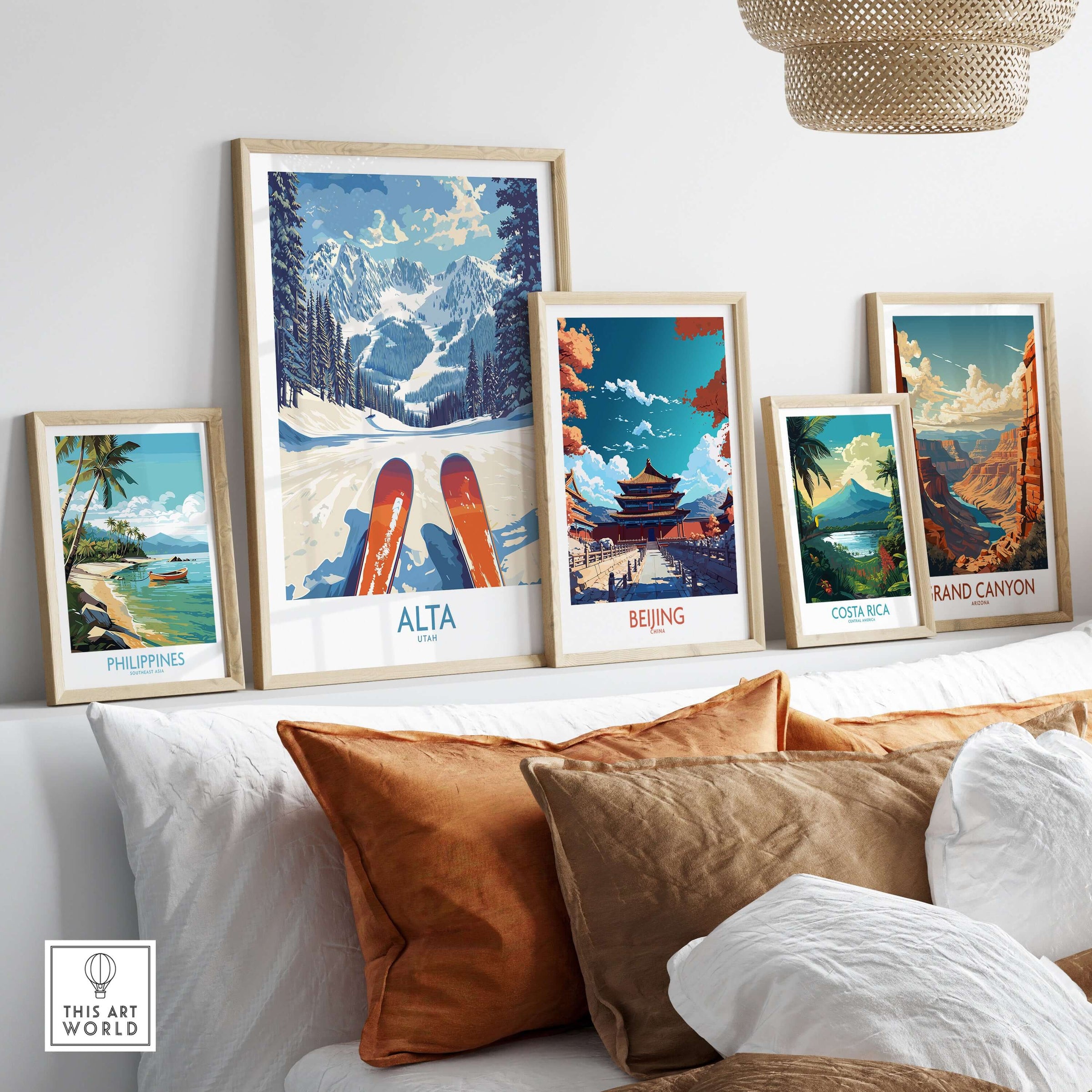 Framed travel posters including Alta Utah, Beijing, Costa Rica, and the Grand Canyon on a stylish sofa.