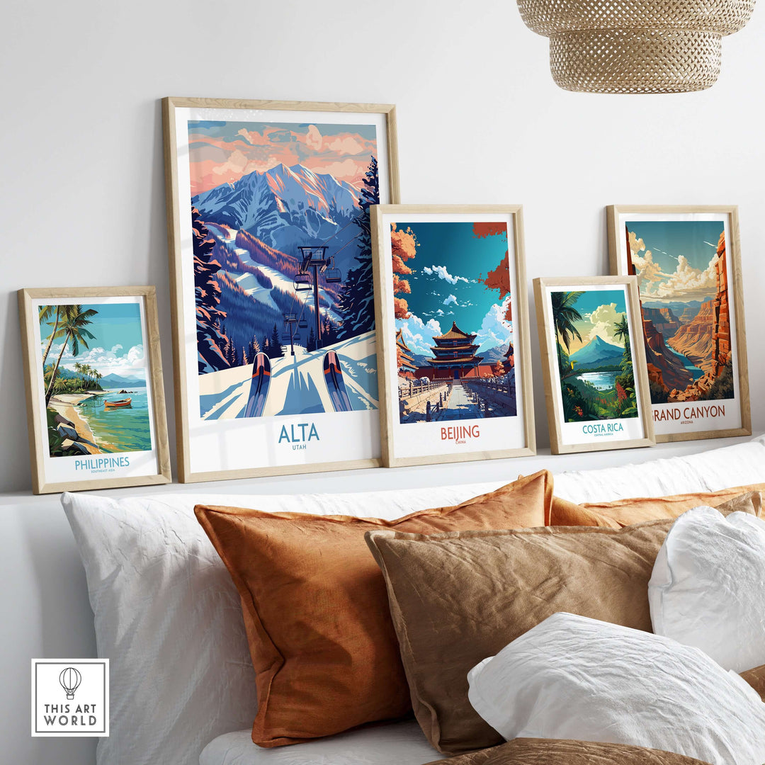 Framed travel prints featuring Alta Utah, Beijing, Costa Rica, and the Philippines displayed on a cozy couch.