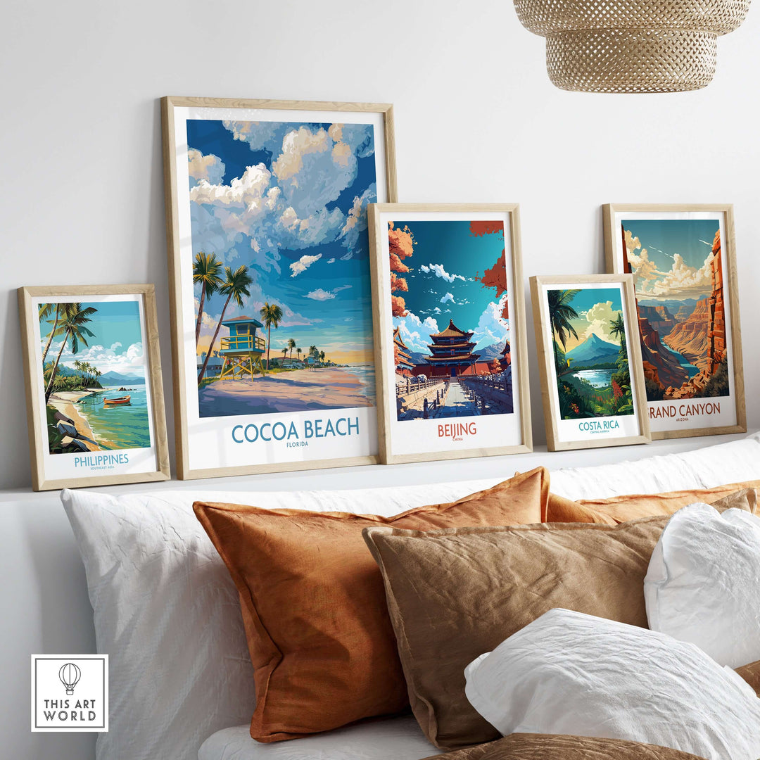 Framed landscape prints featuring Cocoa Beach, Philippines, Beijing, Costa Rica, and Grand Canyon on a sofa.