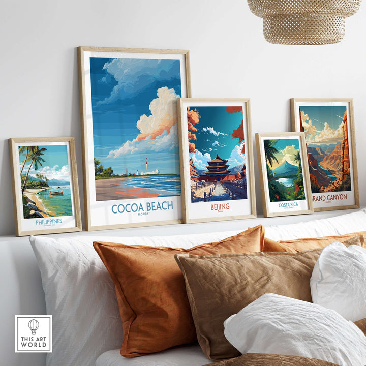 Framed travel posters including Cocoa Beach, Beijing, Costa Rica, and the Grand Canyon on a stylish couch.