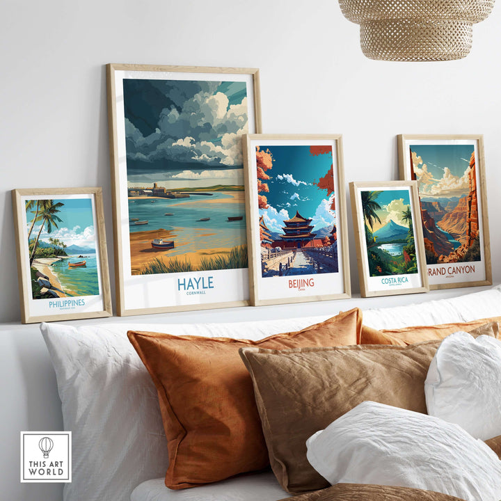 Gallery of framed travel posters including Hayle, Philippines, Beijing, Costa Rica, and Grand Canyon on a cozy sofa.