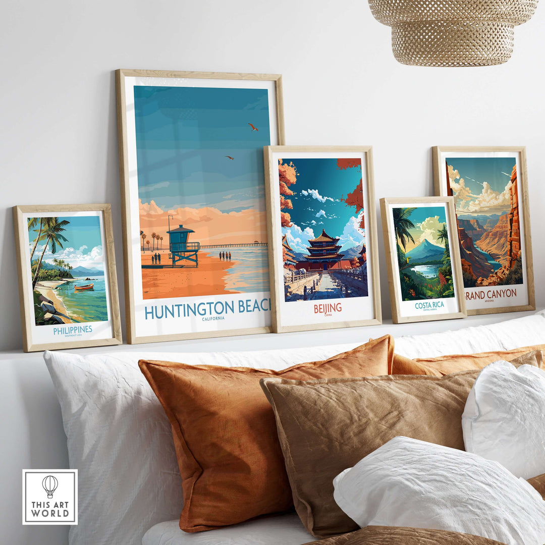 Framed travel posters showcasing Huntington Beach, Beijing, Costa Rica, Grand Canyon, and Philippines on a cozy couch.