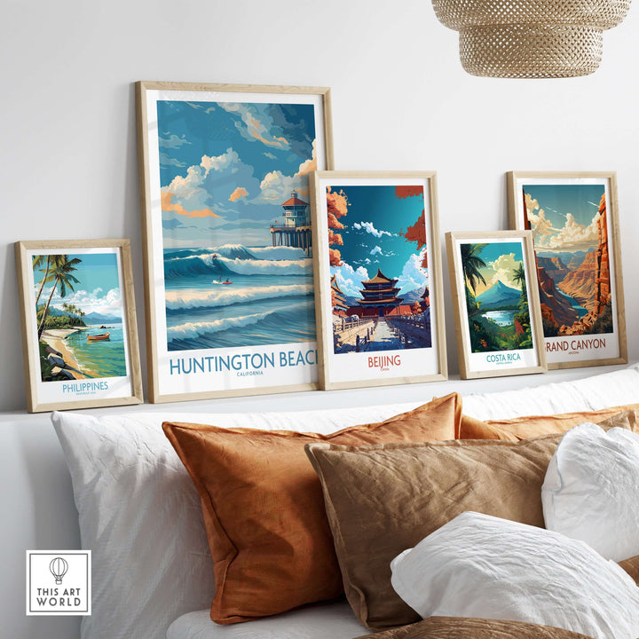 Huntington Beach California surfing poster among vibrant travel prints on a cozy sofa, enhancing beach-themed decor.