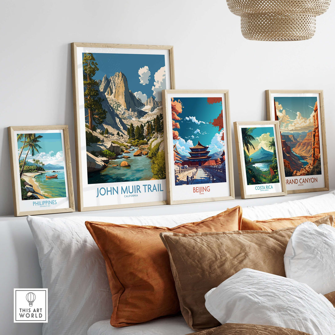 John Muir Trail poster alongside travel prints from Philippines, Beijing, Costa Rica, and Grand Canyon in a cozy home setting.
