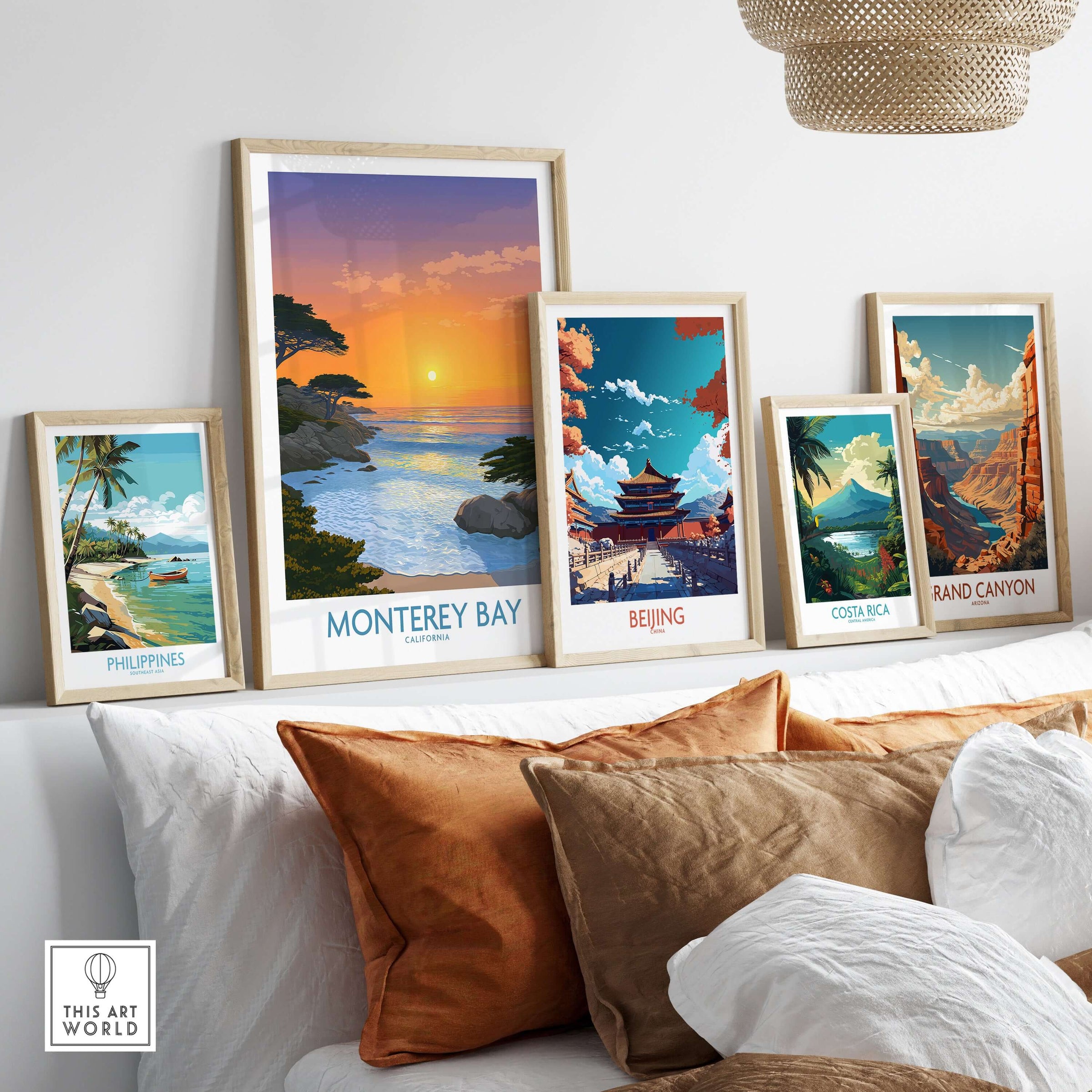Monterey Bay California Poster - California Beach Print displayed among various travel posters on a cozy sofa.