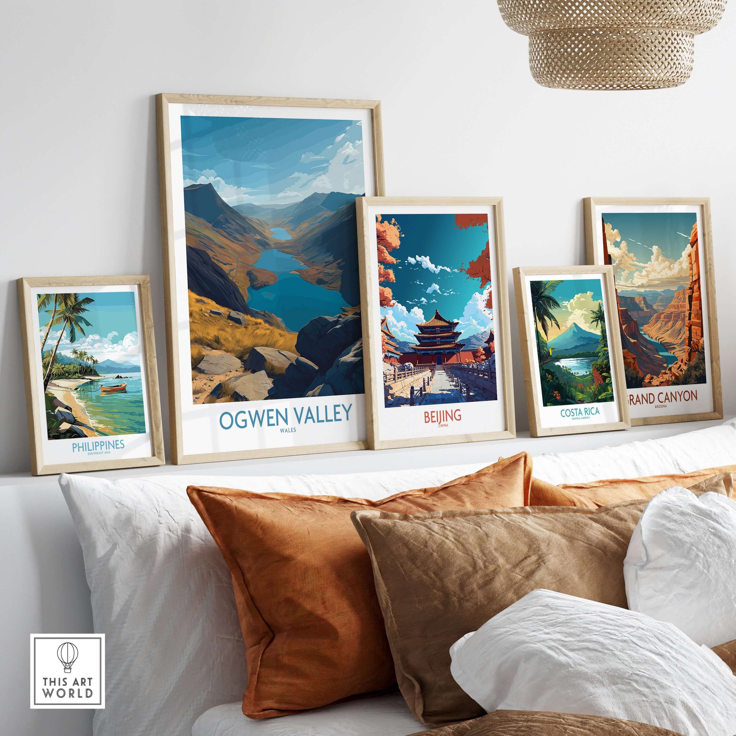Ogwen Valley Wales Poster Blue Lakes & Peaks - Welsh Wilderness Decor displayed among other travel posters in a cozy living room.