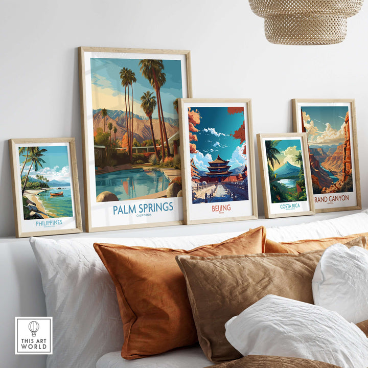Colorful travel art prints, including Palm Springs, displayed on a stylish shelf above cozy cushions.