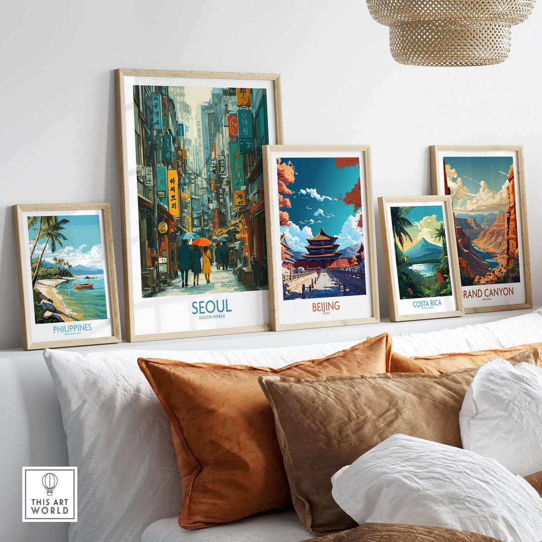 Seoul poster with vibrant city life art print among other travel-themed framed prints on a stylish shelf.