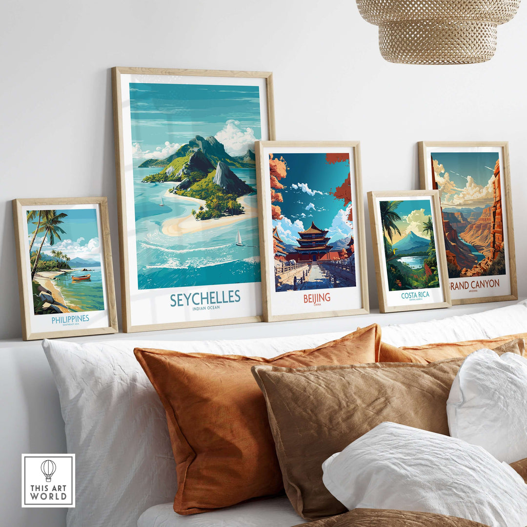 Framed travel posters, including Seychelles Indian Ocean and Philippines, displayed on a cozy sofa, enhancing home decor.