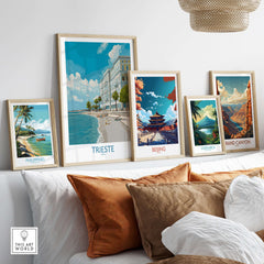 Trieste Print Italy Seafront Poster displayed among other destination posters on a stylish sofa.