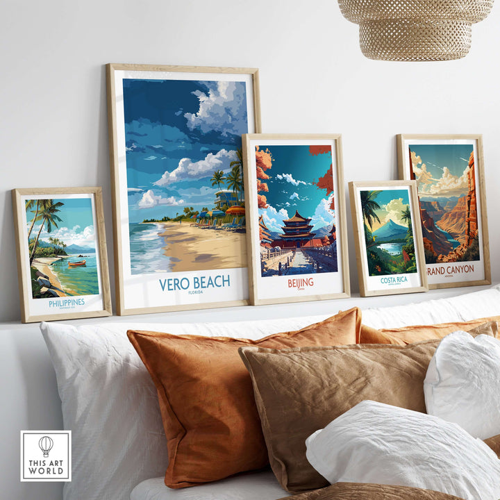 Vero Beach sunny beach umbrellas poster among framed travel art prints on a stylish sofa, capturing Florida vacation vibes.