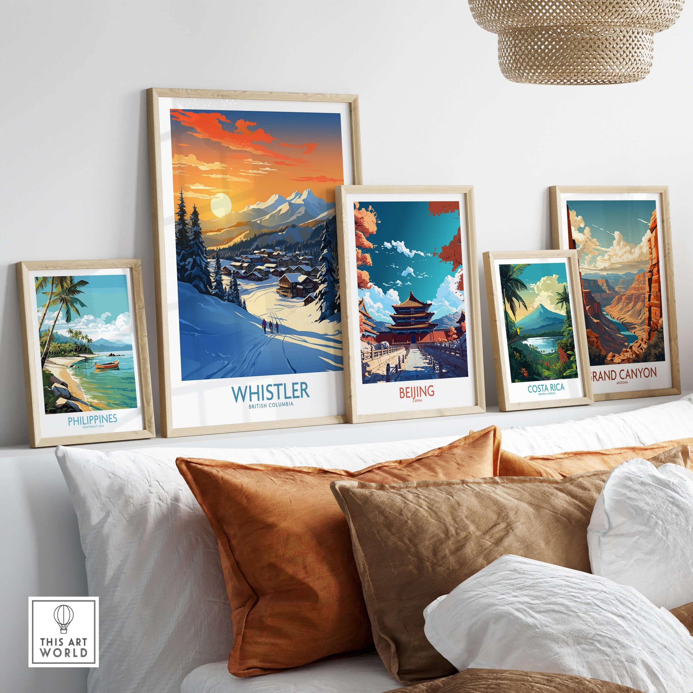 Framed Whistler ski poster surrounded by other travel-themed art prints on a cozy couch, perfect for home decor.