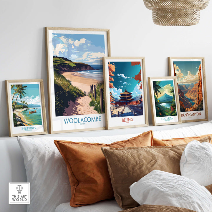 Framed posters of Woolacombe, Philippines, Beijing, Costa Rica, and Grand Canyon displayed on a modern shelf.