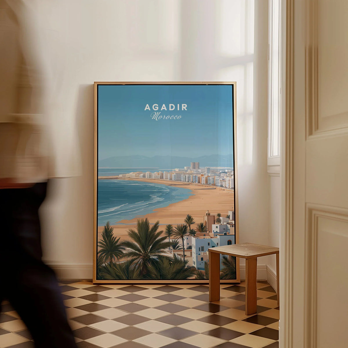 Agadir Morocco Poster – Travel Print as a framed canvas leaning in a hallway with a chequered tiled floor