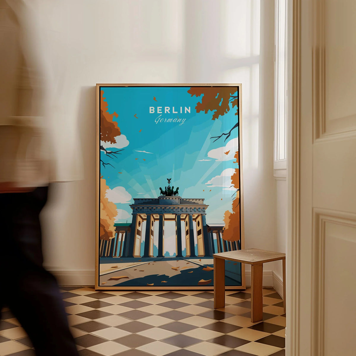 Berlin Poster Blue Sky as a framed canvas leaning in a hallway with a chequered tiled floor