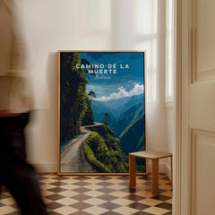 Camino de la Muerte Poster Bolivia Wall Art as a framed canvas leaning in a hallway with a chequered tiled floor