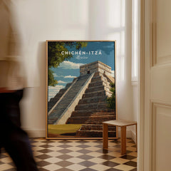 Chichén Itzá Mexico Travel Print El Castillo Pyramid Poster Mayan Ruins Wall Art as a framed canvas leaning in a hallway with a chequered tiled floor