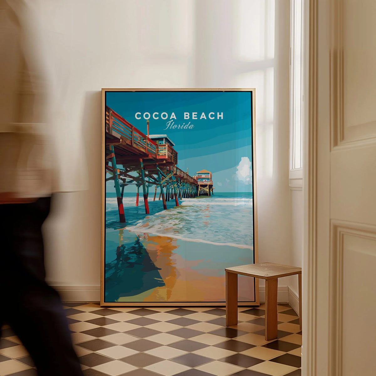 Cocoa Beach Florida Pier Print - Coastal Florida Wall Art as a framed canvas leaning in a hallway with a chequered tiled floor