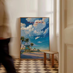 Cocoa Beach Lifeguard Tower Poster - Palm Tree Beach Wall Art as a framed canvas leaning in a hallway with a chequered tiled floor