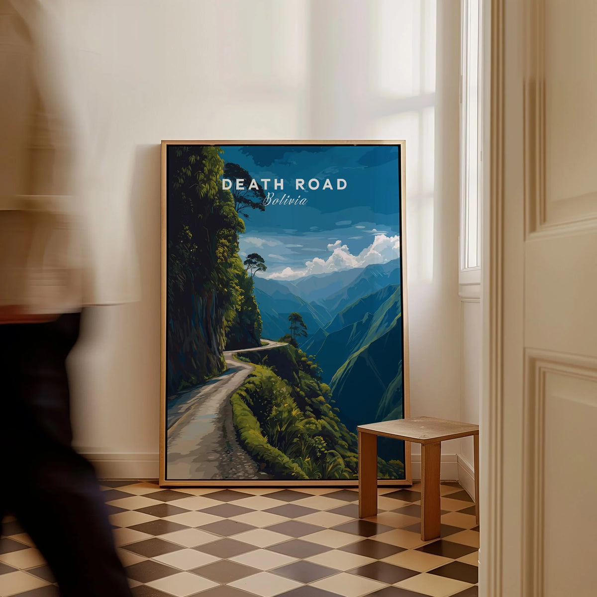 Death Road Print | South America Adventure Decor | Yungas Road Poster as a framed canvas leaning in a hallway with a chequered tiled floor