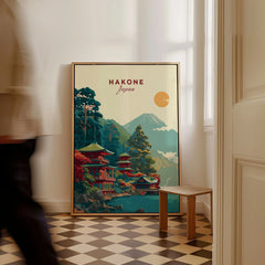 Hakone Japan Lake Ashi Temple Print - Japanese Pagoda Wall Art as a framed canvas leaning in a hallway with a chequered tiled floor
