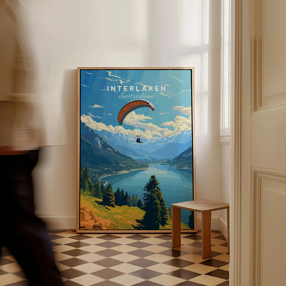 Interlaken Switzerland Poster as a framed canvas leaning in a hallway with a chequered tiled floor