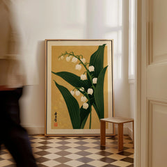Lily of the Valley Print – Gold Japanese Botanical Wall Art — framed canvas on floor man walking past