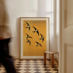 Swallows Art Print – Gold Japanese Bird Wall Art — framed canvas on floor man walking past