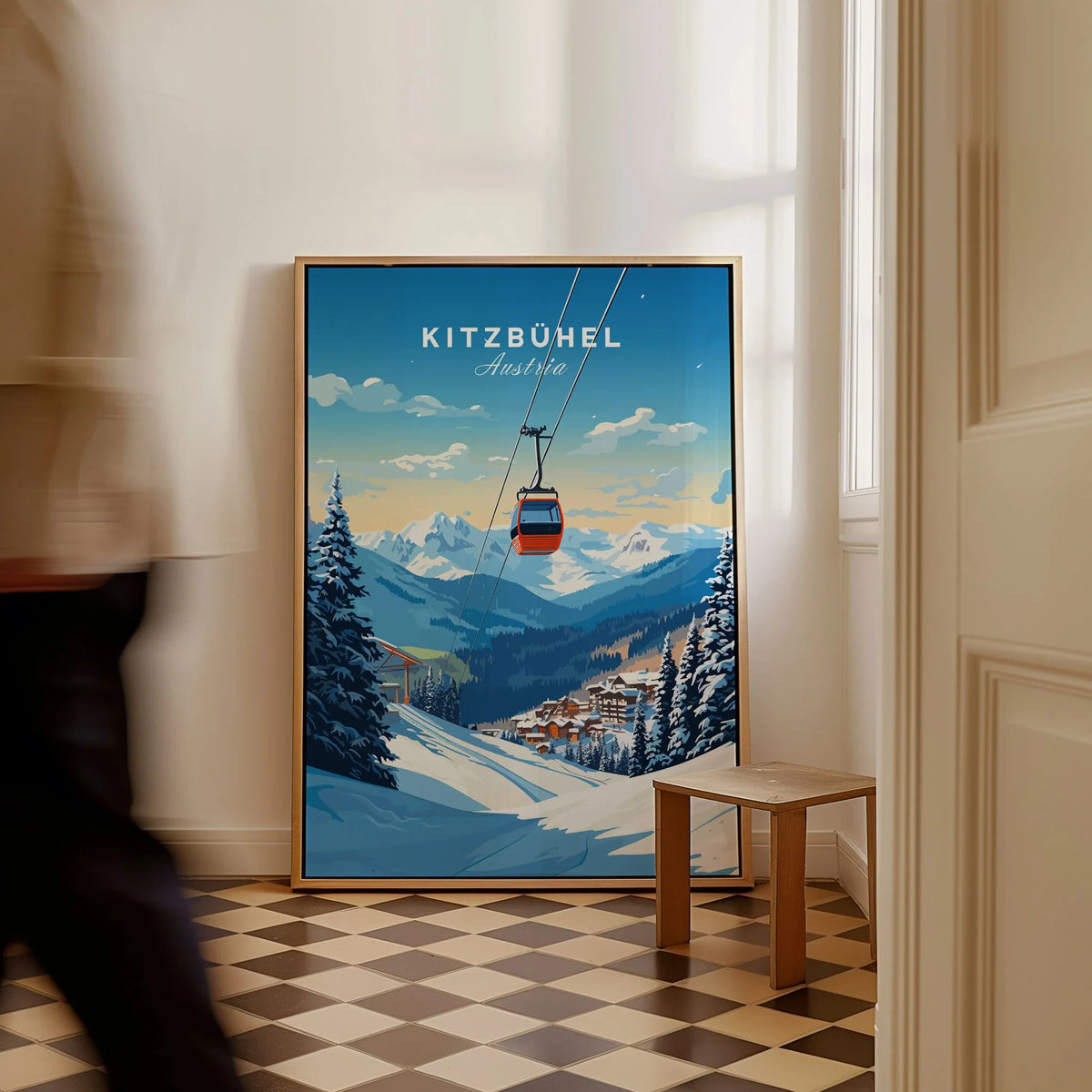 Kitzbuhel Art Print as a framed canvas leaning in a hallway with a chequered tiled floor