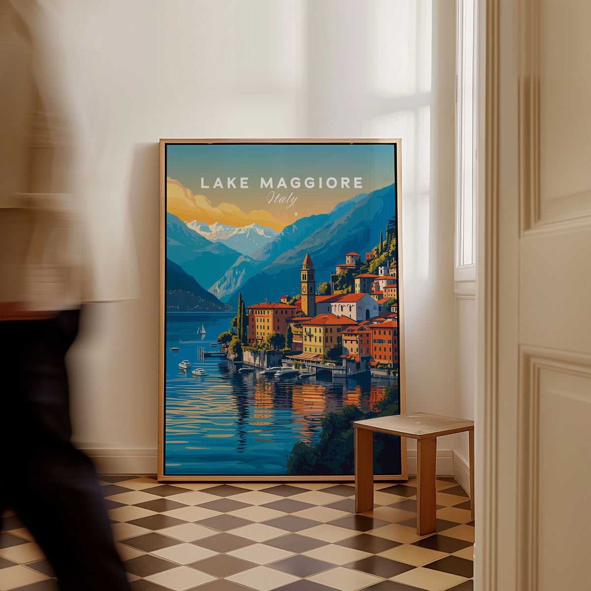 Lake Maggiore Print as a framed canvas leaning in a hallway with a chequered tiled floor