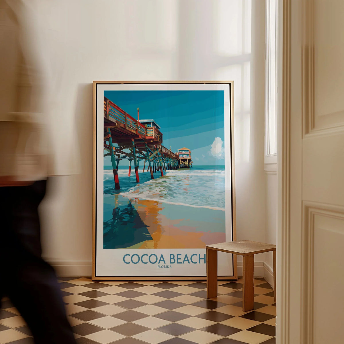 Cocoa Beach Pier Poster - Florida Beach Travel Decor as a framed canvas leaning in a hallway with a chequered tiled floor