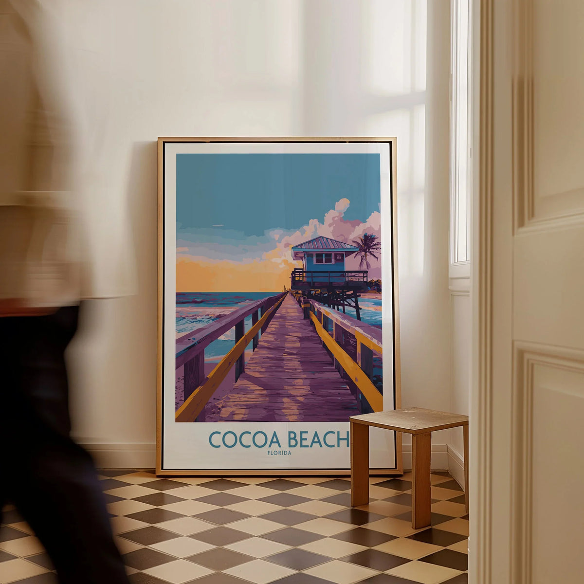 Cocoa Beach Florida Wooden Pier Poster - Golden Hour Sunset Decor as a framed canvas leaning in a hallway with a chequered tiled floor