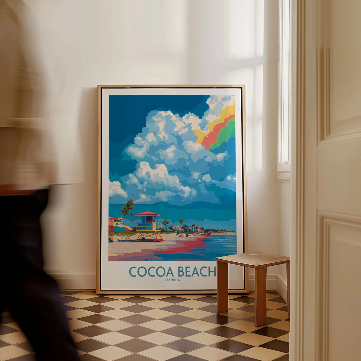 Cocoa Beach Rainbow Cloud Poster - Florida Travel Decor as a framed canvas leaning in a hallway with a chequered tiled floor