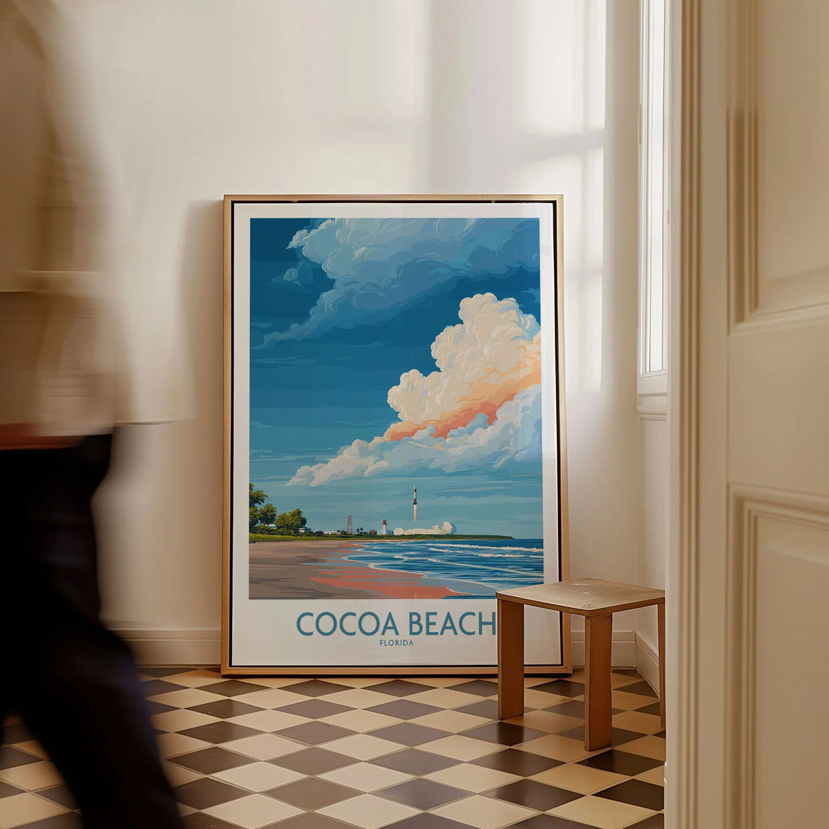 Cocoa Beach Kennedy Space Center Poster - Florida Wall Art Decor as a framed canvas leaning in a hallway with a chequered tiled floor