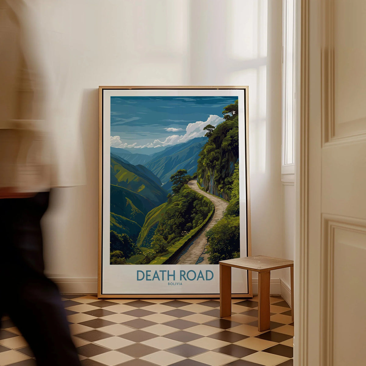 Death Road Bolivia Art Print | Yungas Road Poster as a framed canvas leaning in a hallway with a chequered tiled floor