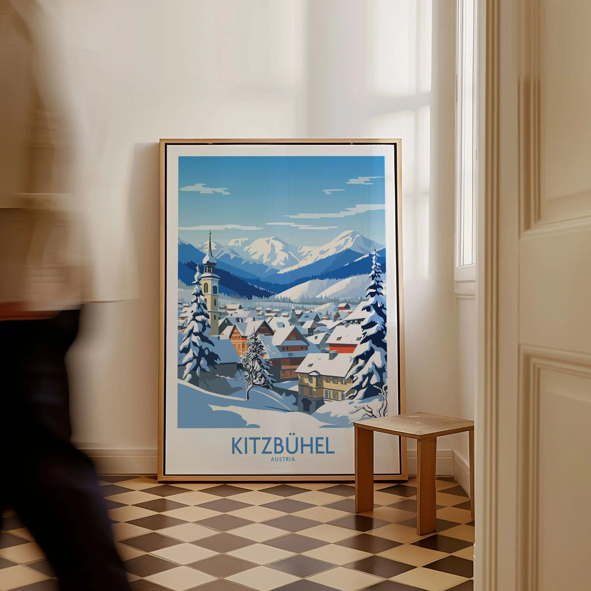Kitzbuhel Austria Art Print as a framed canvas leaning in a hallway with a chequered tiled floor