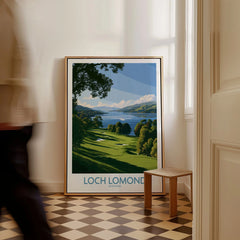 Loch Lomond Scotland Lochside Meadow Wall Art — a sunlit grassy shoreline running down to Loch Lomond under old oaks, shown as framed canvas on floor man walking past