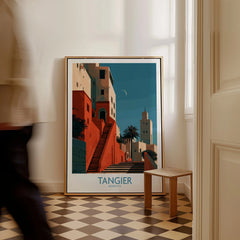 Tangier Morocco Crescent Moon Wall Art — coral kasbah steps climbing towards a minaret under a crescent moon, shown as framed canvas on floor man walking past
