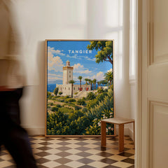 Tangier Morocco Cap Spartel Lighthouse Travel Poster — the Cap Spartel lighthouse above palm gardens and the blue strait, shown as framed canvas on floor man walking past