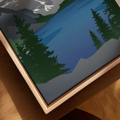 Close-up of framed canvas wall art featuring a scenic lake, pine trees, and mountain landscape