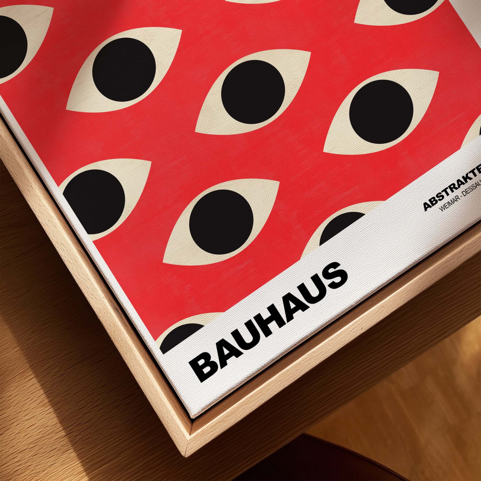 Bauhaus Exhibition Prints - Repeating Eyes Pattern Poster Red Black Cream Art displayed in a wooden frame with abstract eye design.