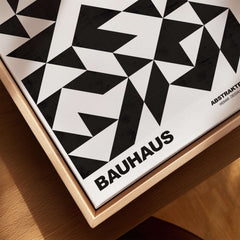 Bauhaus Exhibition Prints - Geometric Triangle Pattern Poster Black White Abstract displayed with bold black triangles