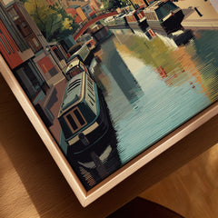 Close up of framed canvas wall art featuring a colorful city canal and boats scene.