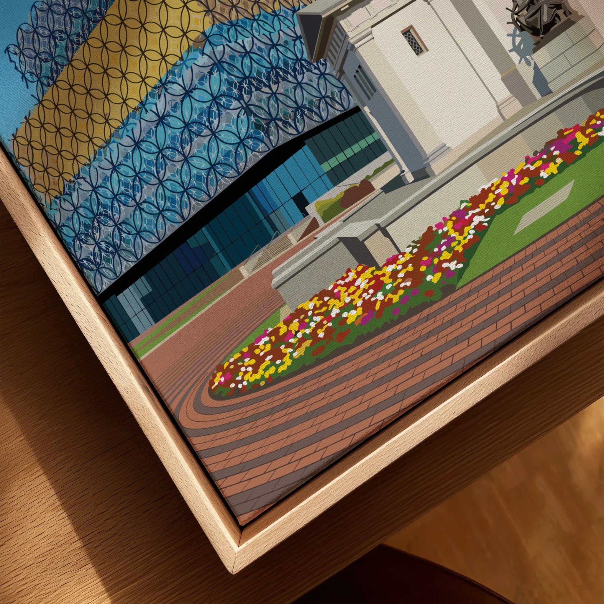 Close-up of framed city skyline wall art with colorful flowers and modern architecture