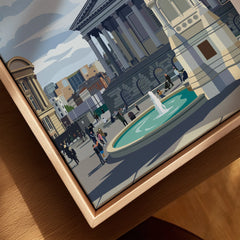 Close-up of framed cityscape canvas art with a fountain, classic buildings, and people