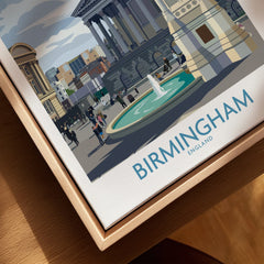 Closeup of framed Birmingham England cityscape wall art print with natural wood frame
